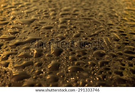 natural rain drops on glass golden bronze  background