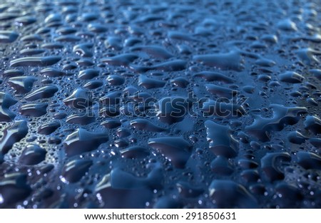 natural rain drops on glass blue  background