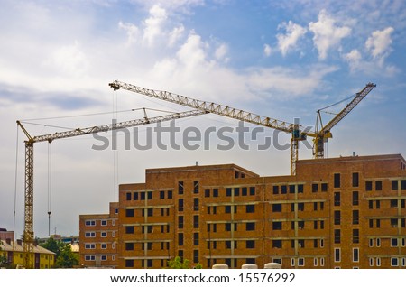 three high heavy cranes on construction new big house