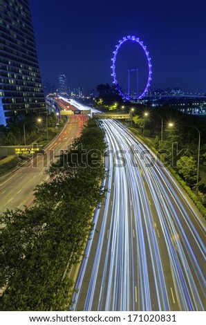 The colorful night traffic of Singapore road, the way to Singapore flyer.