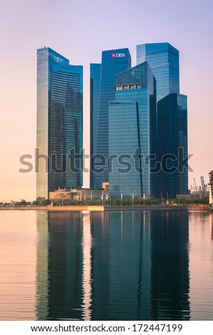 SINGAPORE - Jan 21 : The Marina Bay Financial Center skyscrapers reflect water on morning Jan 21, 2014 in Singapore. Singapore is the world\'s fourth leading financial center and hub of Asia.