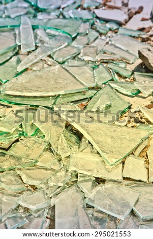 Broken mirror glass shards spread on the floor