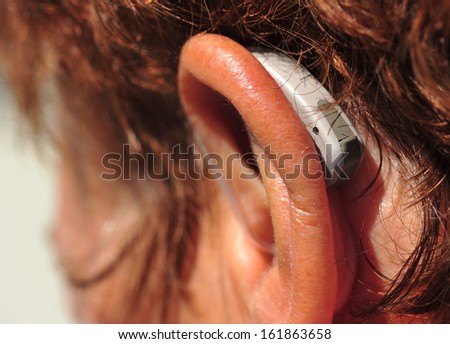 close-up of hearing aid on the woman\'s ear