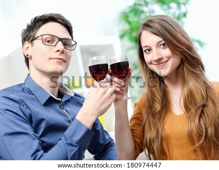 Very beautiful young couple toasting wine glasses