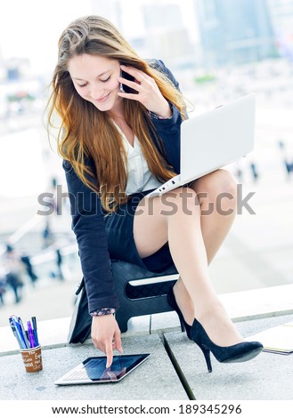 Junior executive dynamic phoning outside of her office