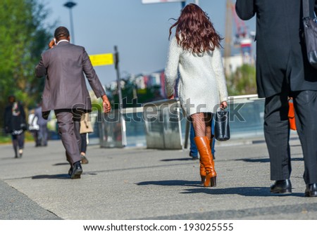 Back view of rush hour, city workers going to work