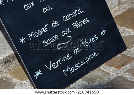 Closeup on menu board outside a French restaurant