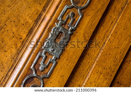 Closeup on old wood cabinet with its old key