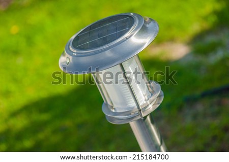 Closeup to a solar lighting device  on the background of green garden