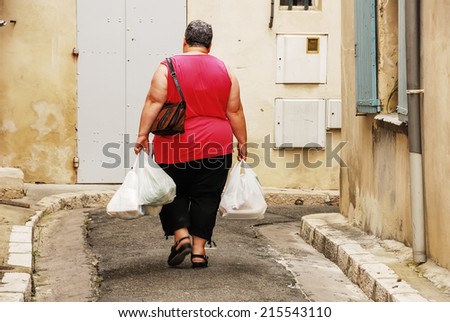 a woman that\'s going home with her groceries