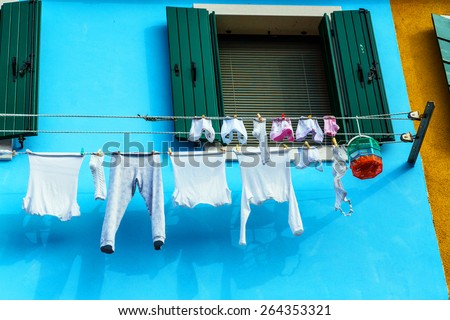 Colorful house in Burano with the laundry drying on a wire