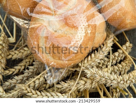 Buns in a plastic bag with wheat horizontal