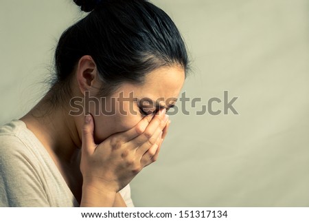 Young woman crying and wiping tears, with fashion tone