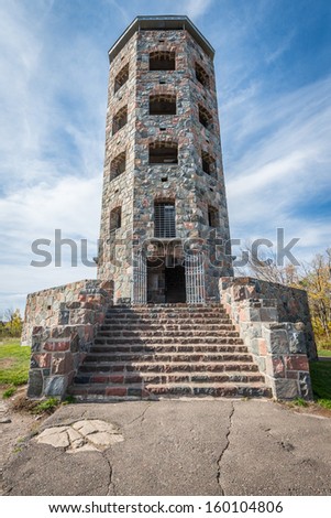 Front entrance of a stone tower during autumn time