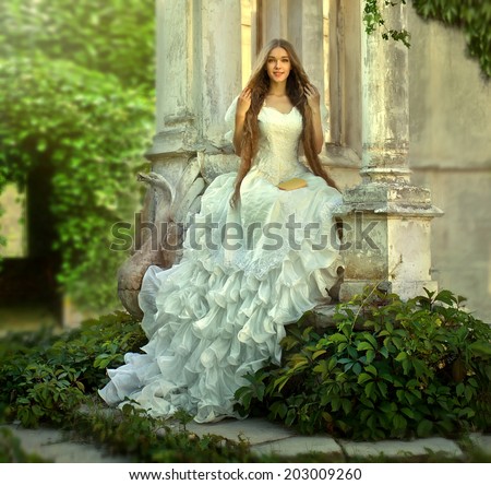 Young attractive girl Fairy tale with princess in old medieval garden Young attractive girl Fairy tale with princess in old medieval garden