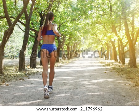 Runner - woman running outdoors training for marathon run.Female fitness concept