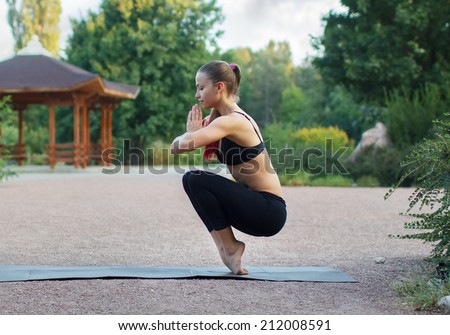 Good morning with yoga.Beautiful young caucasian woman in fitness wear doing exercises in a park