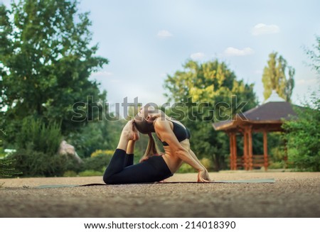Good morning with yoga.Beautiful young caucasian woman in fitness wear doing exercises in a park