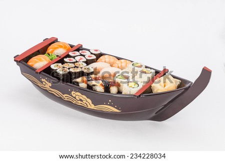 Various kind of sushi food served on boat capacity.Different Types of Maki Sushi and Nigiri Sushi