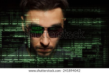 Silhouette of a hacker on graphic user interface