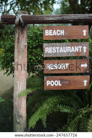 service guide.decorative list of services on wooden tablets with words beach,restaurant,resort and pool
