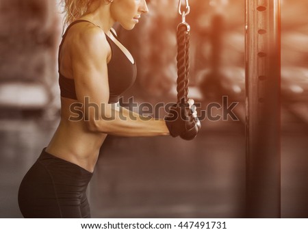 Muscular fitness woman doing exercises.Concept of healthy lifestyle. Cross fit bodybuilder  in the gym.