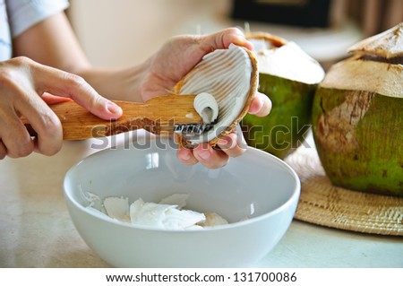grating coconut for making coconut cake
