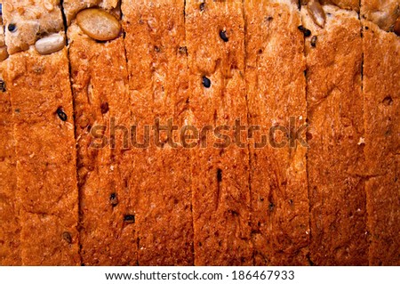 Close up Sliced Cut Loaf Whole Wheat Grain Bread with pumpkin seed , nut and sesame for background, wallpaper and texture.