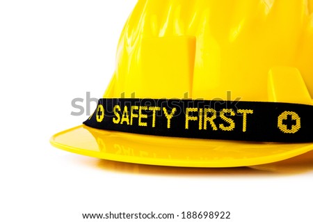 Close up Yellow Safety Helmet Hat with SAFETY FIRST word tag isolated on white background.