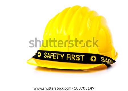 Yellow Safety Helmet Hat with SAFETY FIRST word tag isolated on white background.