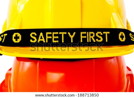 Close up Pair of Engineer Worker Helmet two Orange and Yellow with SAFETY FIRST tag design concept isolated on white background.