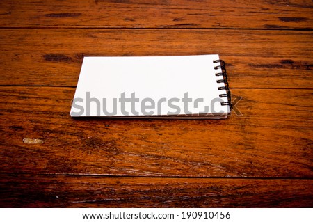 Paper Short Note Book on Wooden Table Rustic Style / write down your text here, background and texture.