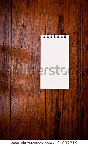 Paper Short Note Book on Wooden Table Rustic Style / write down your text here, background and texture.