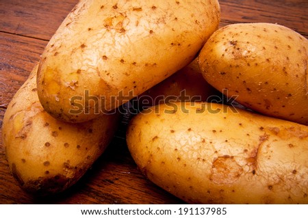 Close up Group of Fresh Potato on Wood Table , Country Rustic Style.