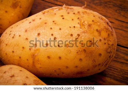 Close up of Fresh Potato on Wood Table , Country Rustic Style.