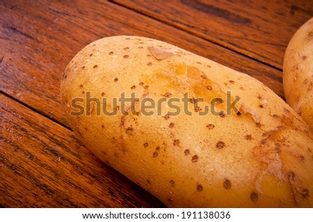 Close up of Fresh Potato on Wood Table , Country Rustic Style.