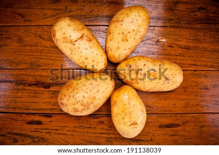 Group of Five Fresh Potato Arrange on Star Shape on Wood Table , Country Rustic Style.