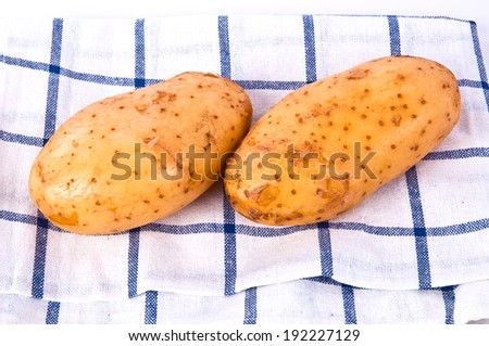 Fresh Potato Harvest From Farm with Checked Cotton Table Fabric Vintage Country Style isolated on white background.