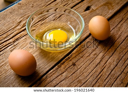 Fresh Egg With Bowl of Egg White on Wooden Table, Food Rustic Style.