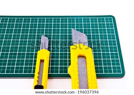 Two Big and Small Stationery Knife Paper Cutter isolated on a white background. Concept Idea of Art and Craft.
