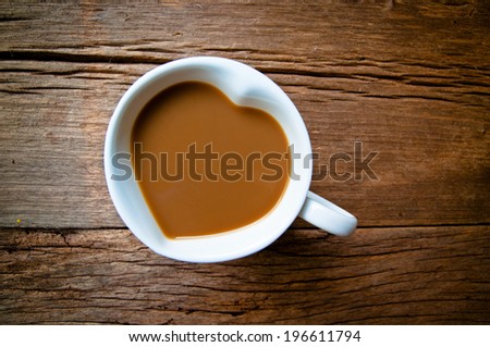 Coffee Mug in Design of Heart Shape on Wood Table Background, Rustic Style / Concept and idea of coffee love, romantic.