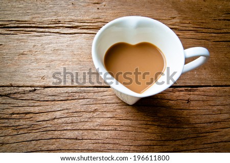 Coffee Mug in Design of Heart Shape on Wood Table Background, Rustic Style / Concept and idea of coffee love, romantic.