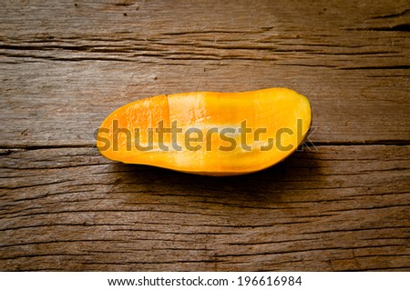 Fresh Mango , Cut in Half Shape Concept of Food Art, Idea of Decorated Food, On Wood Table Background, Rustic Style.