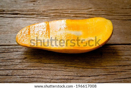 Fresh Mango , Cut in Half Shape Concept of Food Art, Idea of Decorated Food, On Wood Table Background, Rustic Style.