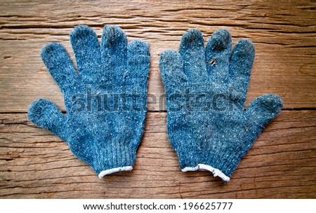 Old Navy Blue Gloves, Gardener, Worker, Carpenter Concept and Idea / On Wood Background, Rustic Style.