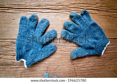 Old Navy Blue Gloves, Gardener, Worker, Carpenter Concept and Idea / On Wood Background, Rustic Style.