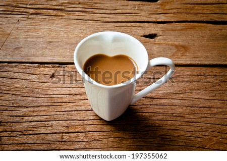 Coffee Mug in Design of Heart Shape, Love and Romantic or Valentine's Concept and idea on Wood Table Background, Rustic Style.