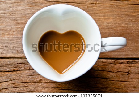 Coffee Mug in Design of Heart Shape, Love and Romantic or Valentine\'s Concept and idea on Wood Table Background, Rustic Style.