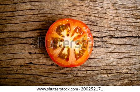 Half Cut Sliced of Fresh Tomato on Wood Table Background, Rustic Still Life Style.