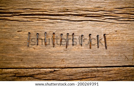 Old Vintage Rust Nails on Wood Table Background, Rustic Style.